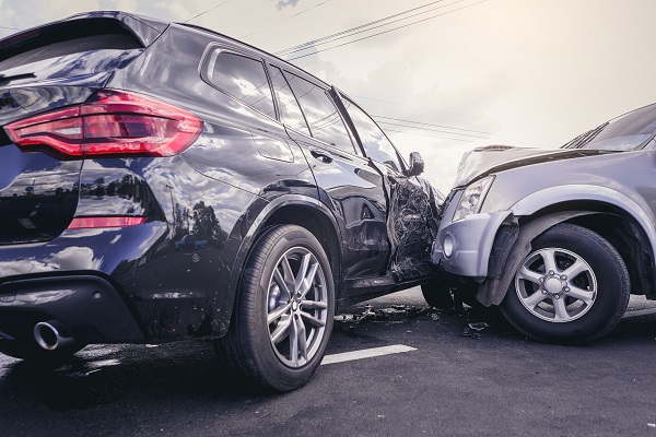 A traffic collision involving a black vehicle and a gray vehicle